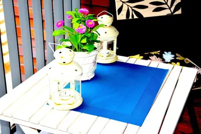 a white table with two snowmen and a potted plant at Apartament nad Wisłą in Kraków
