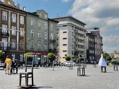 a woman in a white dress is standing in a city at Apartament nad Wisłą in Kraków