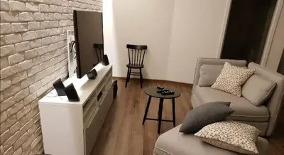 a living room with a couch and a brick wall at Apartament nad Wisłą in Kraków