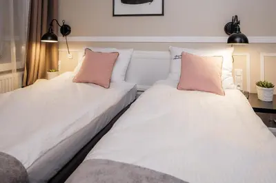 two beds sitting next to each other in a room at Imagine Apartments in Kraków