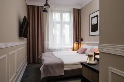 a hotel room with a bed and a window at Imagine Apartments in Kraków