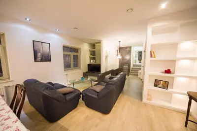 a living room with couches and a couch and a table at Wawel Cracow Old City Apartments - Friendhouse Apartments in Kraków