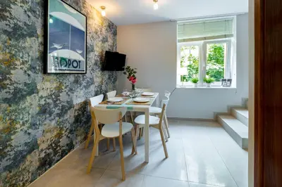 a dining room with a table and chairs at Wawel Cracow Old City Apartments - Friendhouse Apartments in Kraków