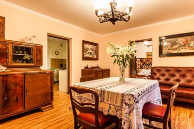 a living room with a table with a vase of flowers on it at Willa Stróża in Myślenice