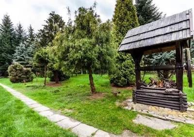 a gazebo in a park with a fire pit at Willa Stróża in Myślenice