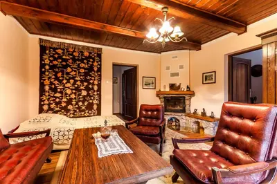a living room with a table and chairs at Willa Stróża in Myślenice