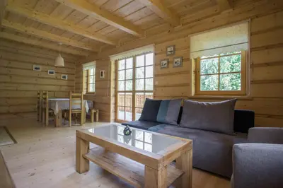 a kitchen with white appliances and a wooden ceiling at Mosorny Park Drewniane Komfortowe Domki Całoroczne in Zawoja