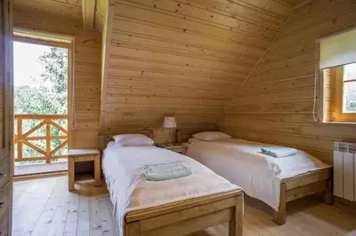 a bathroom with a sink and a toilet and a mirror at Mosorny Park Drewniane Komfortowe Domki Całoroczne in Zawoja