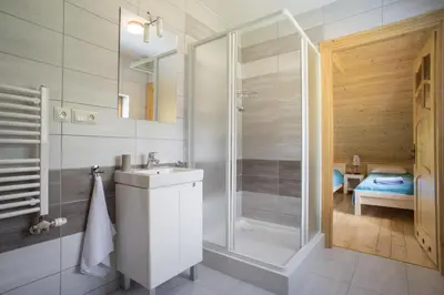 a bedroom in a log cabin with a bed and a desk at Mosorny Park Drewniane Komfortowe Domki Całoroczne in Zawoja