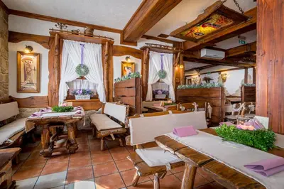 a restaurant with tables and chairs in a room at Hotel - Karczma Klimtówka in Wolbrom