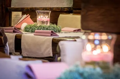 a table with pink napkins and a glass on it at Hotel - Karczma Klimtówka in Wolbrom