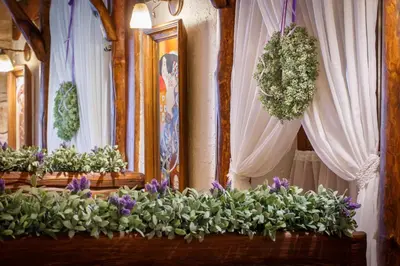 a row of flowerpots with purple and white flowers at Hotel - Karczma Klimtówka in Wolbrom