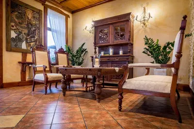 a dining room with a wooden table and chairs at Hotel - Karczma Klimtówka in Wolbrom