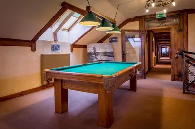 a pool table in the middle of a room at Hotel - Karczma Klimtówka in Wolbrom
