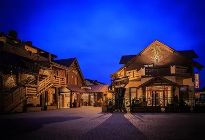 a group of buildings on a street at night at Hotel - Karczma Klimtówka in Wolbrom