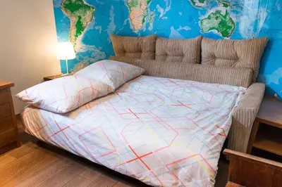 a bedroom with a bed with a map on the wall at Style4rent Apartament Kazimierz in Kraków