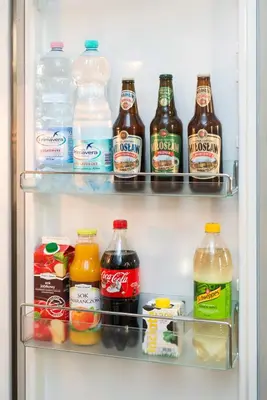 a refrigerator filled with lots of bottles of drinks at Style4rent Apartament Kazimierz in Kraków