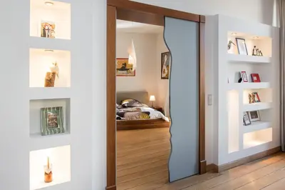 a hallway with a mirror and a room with a bed at Style4rent Apartament Kazimierz in Kraków