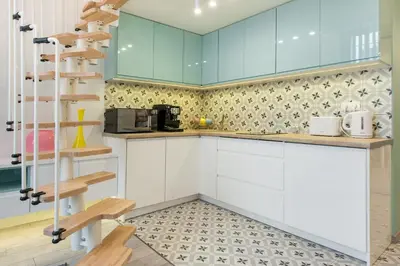 a kitchen with white cabinets and a book shelf at Cheerful Air Conditioned Apartment with mezzanine and Parking - Old Town in Kraków