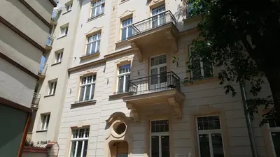 a white building with windows and balconies on it at Cheerful Air Conditioned Apartment with mezzanine and Parking - Old Town in Kraków