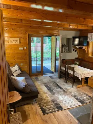 a living room with a couch and a table at Domek Krasnal in Juszczyn