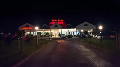 a gas station at night with lights in front of it at Hotel Graal Targowisko in Targowisko