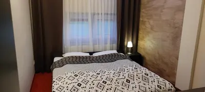 a bedroom with a bed and a window with a curtain at Hotel Graal Targowisko in Targowisko