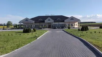 a large building with a road in front of it at Hotel Graal Targowisko in Targowisko