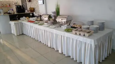 a long white table with food on it at Hotel Graal Targowisko in Targowisko