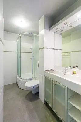a bathroom with a toilet and a sink and a shower at Studio Aleja Pokoju in Kraków