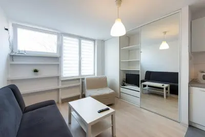 a living room with a couch and a table at Studio Aleja Pokoju in Kraków