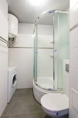 a bathroom with a glass shower and a toilet at Studio Aleja Pokoju in Kraków