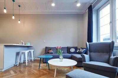 a living room with a couch and a table at PlayRoom II Apartment in Kraków