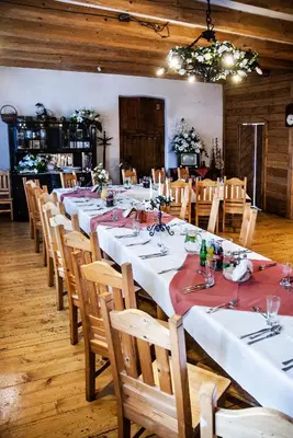 a large dining room with long tables and chairs at Hotel Pod Kogutkiem in Krzywaczka