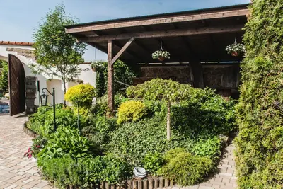 a garden with plants and flowers in front of a building at Hotel Pod Kogutkiem in Krzywaczka