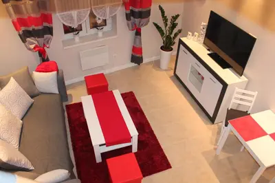 a living room with a couch and a tv at Carmen Apartment in Kraków
