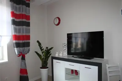 a living room with a flat screen tv on a tv stand at Carmen Apartment in Kraków