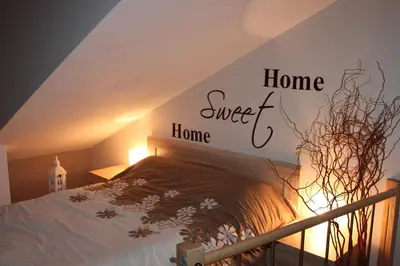 a bedroom with a bed with a sign that reads home sweet home at Carmen Apartment in Kraków