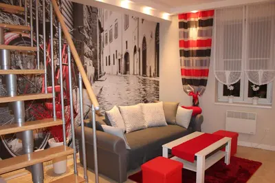 a living room with a couch in the middle of a street at Carmen Apartment in Kraków
