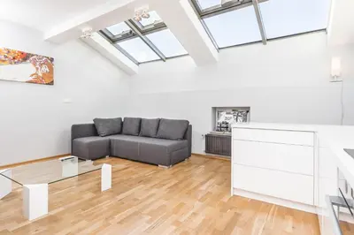 a living room with a couch and a table at Apartment Zegadłowicza in Kraków