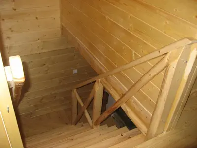 an overhead view of a wooden attic with a wooden stairs at Domek drewniany simonka zawoja in Zawoja