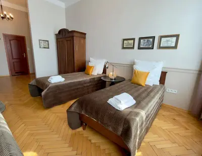 a living room with a couch and a table and a window at Scharffenberg Apartments Main Square in Kraków