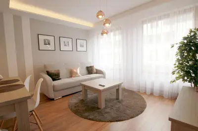a living room with a white couch and a table at Apartment Masarska in Kraków