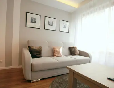 a living room with a couch and a table at Apartment Masarska in Kraków