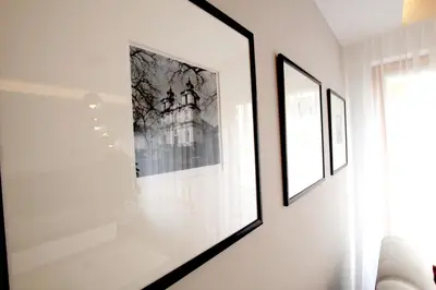 a room with two framed pictures on a wall at Apartment Masarska in Kraków