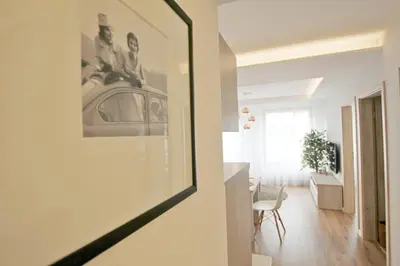a living room with a picture of a car on the wall at Apartment Masarska in Kraków