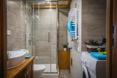 a bathroom with a shower and a toilet and a sink at Top Apartments - Dunin Wąsowicza in Kraków