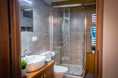 a bathroom with a shower and a sink and a toilet at Top Apartments - Dunin Wąsowicza in Kraków