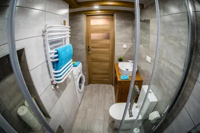 a small bathroom with a toilet and a sink at Top Apartments - Dunin Wąsowicza in Kraków