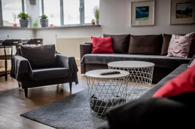 a living room with couches and a table and chairs at Top Apartments - Dunin Wąsowicza in Kraków